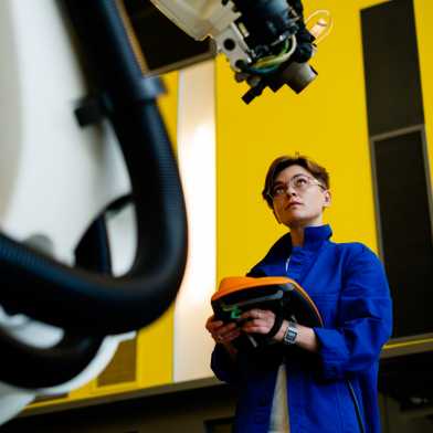 Prof. Maria Yablonina, inside a robotics laboratory.