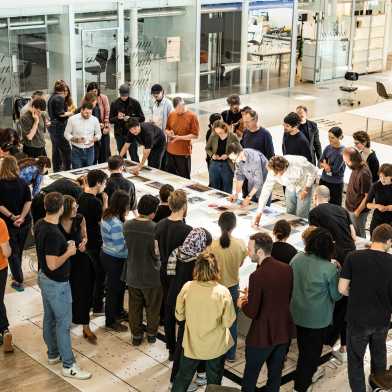 Research Day, researchers gathered around images table, at ITA.